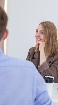 Smiling businesswoman engaged in a positive meeting with colleague.