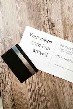 Close-up view of a credit card and welcome letter on a wooden table, emphasizing finance and banking.